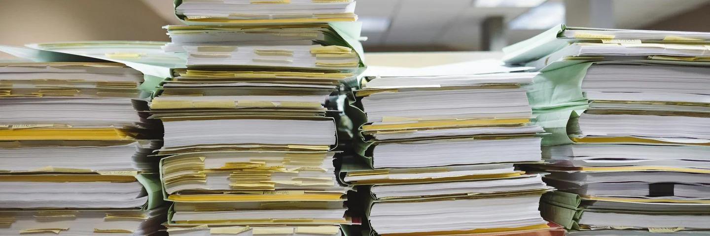 Stacks of paper documents and file folders